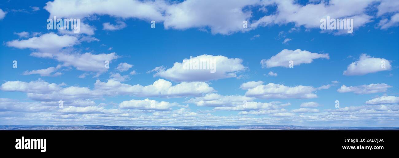 Fluffy clouds in blue sky Stock Photo - Alamy