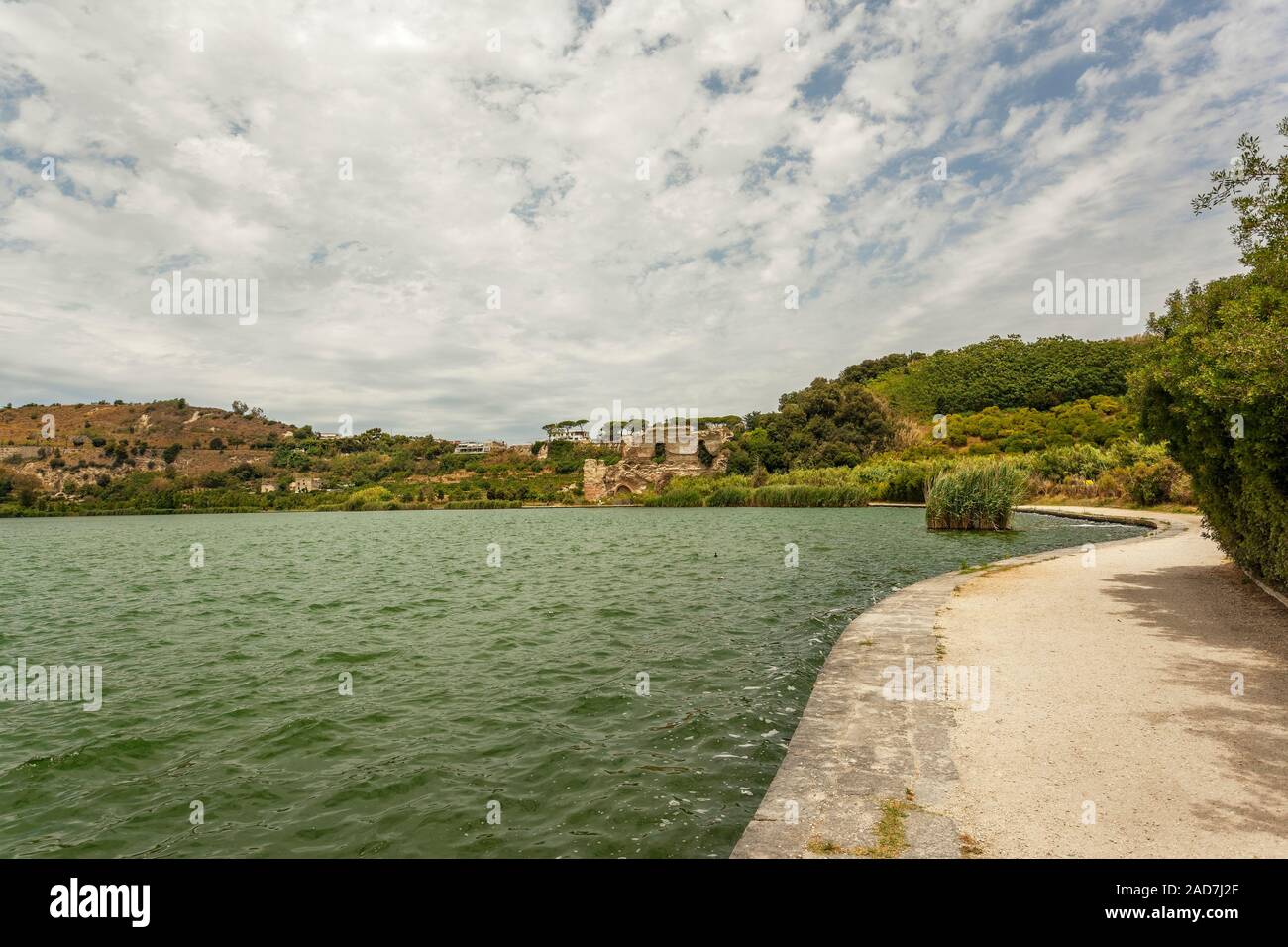 Roman ruins of thermal baths or Temple of Apollo on the edge of Lago d Averno, Cuma, Pozzuoli, Campania Italy, EU Stock Photo