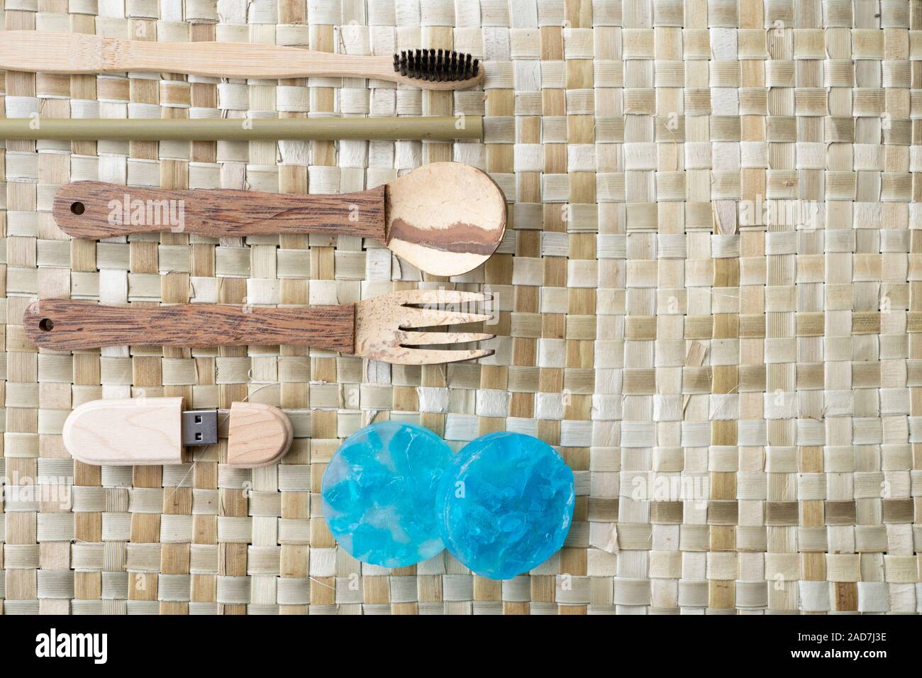 A selection of Eco-friendly travel utensils made in the Philippines. Listed items being a fork,spoon made out of coconut tree wood.A toothbrush & USB Stock Photo