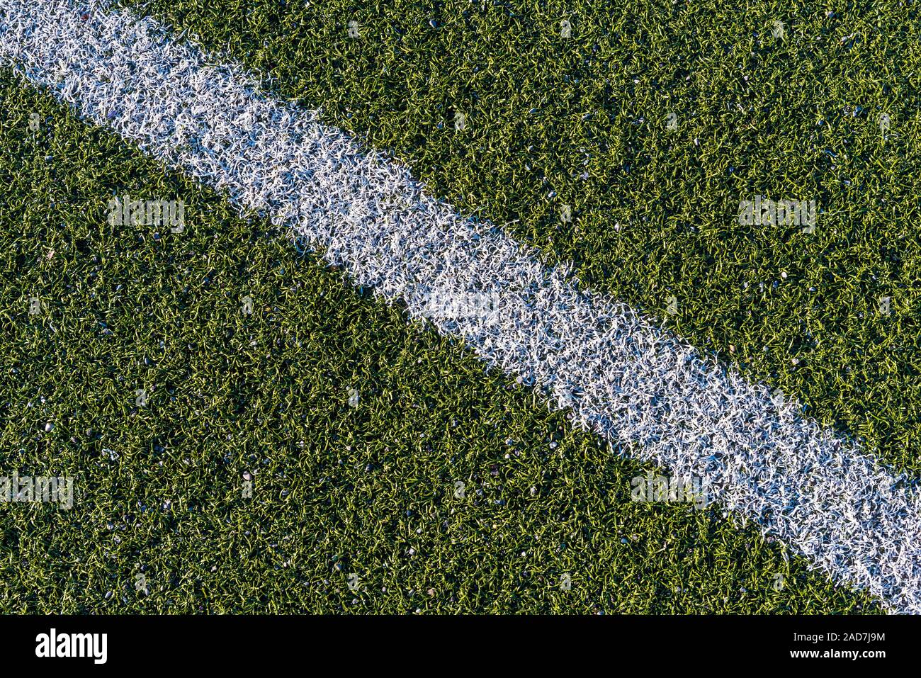 Background from a white line on a green artificial soccer field Stock Photo