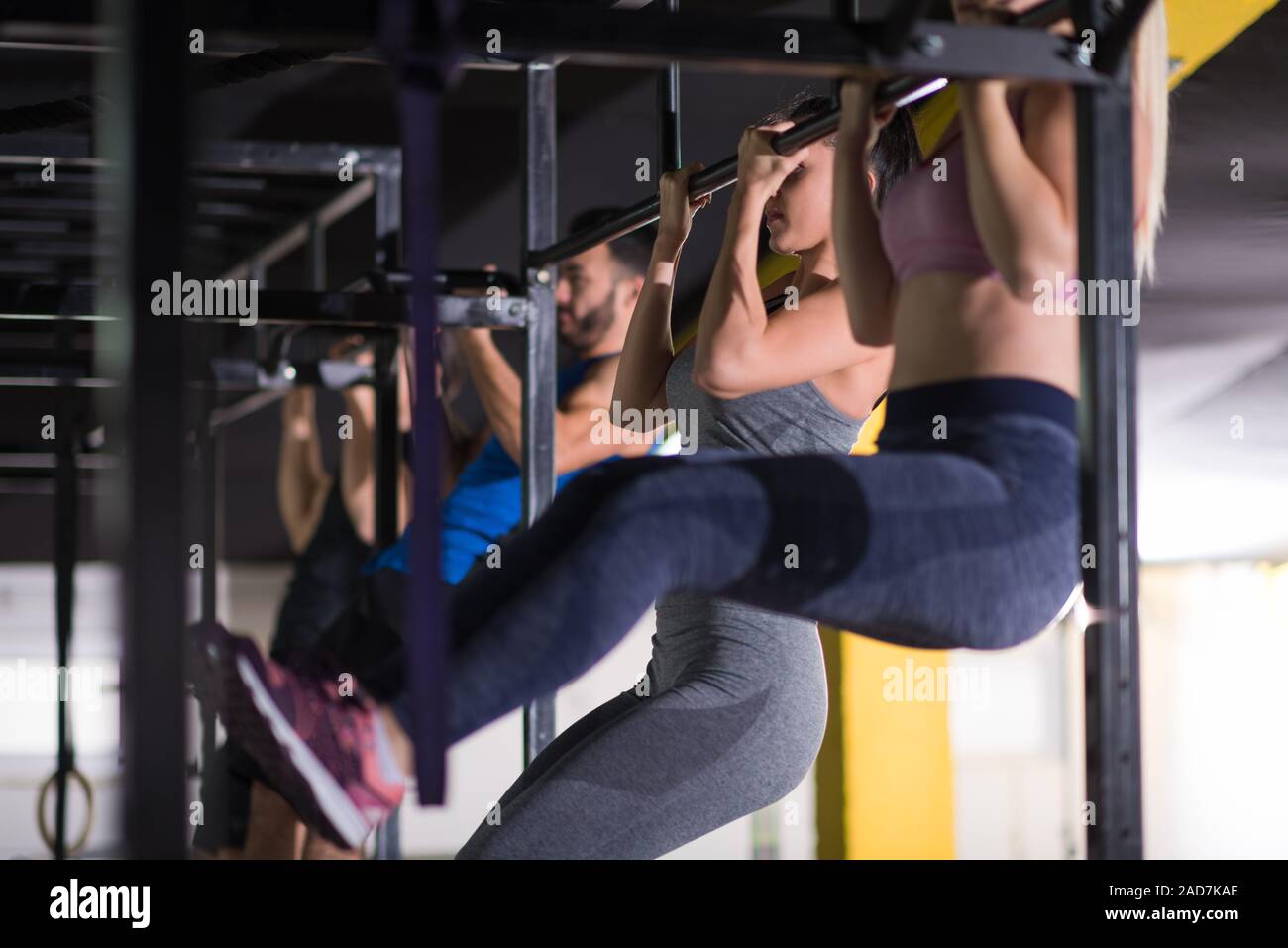 young athletes doing pull ups on the horizontal bar Stock Photo - Alamy