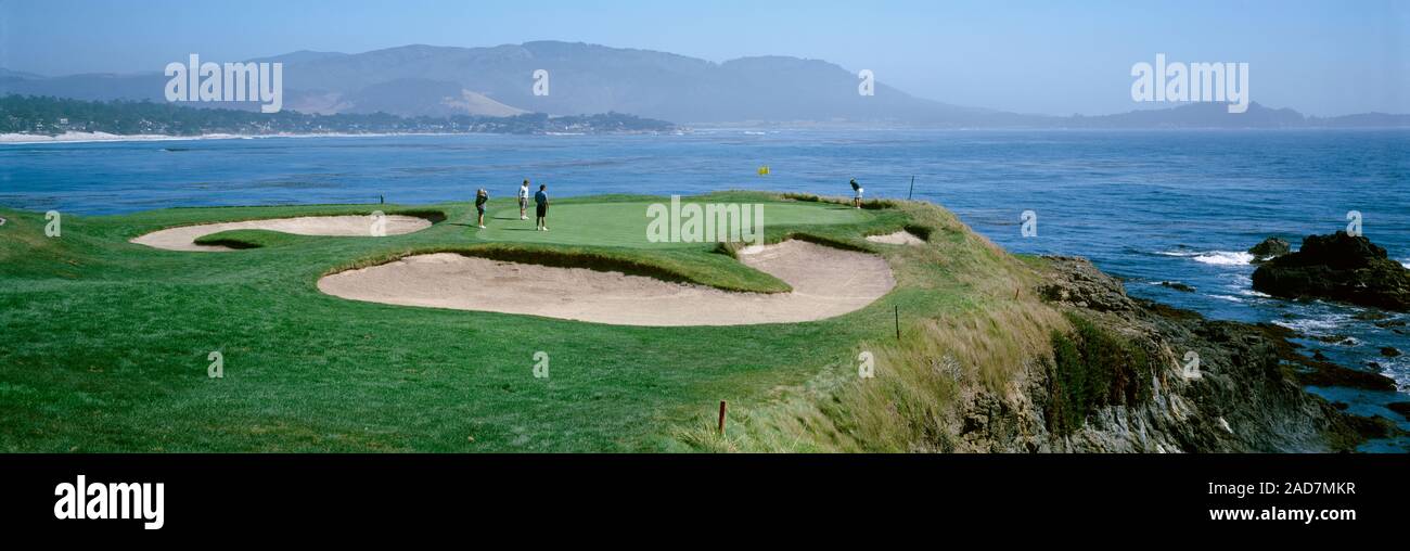 High angle view of people playing golf at a golf course, Pebble Beach Golf Links, Pebble Beach, California, USA Stock Photo