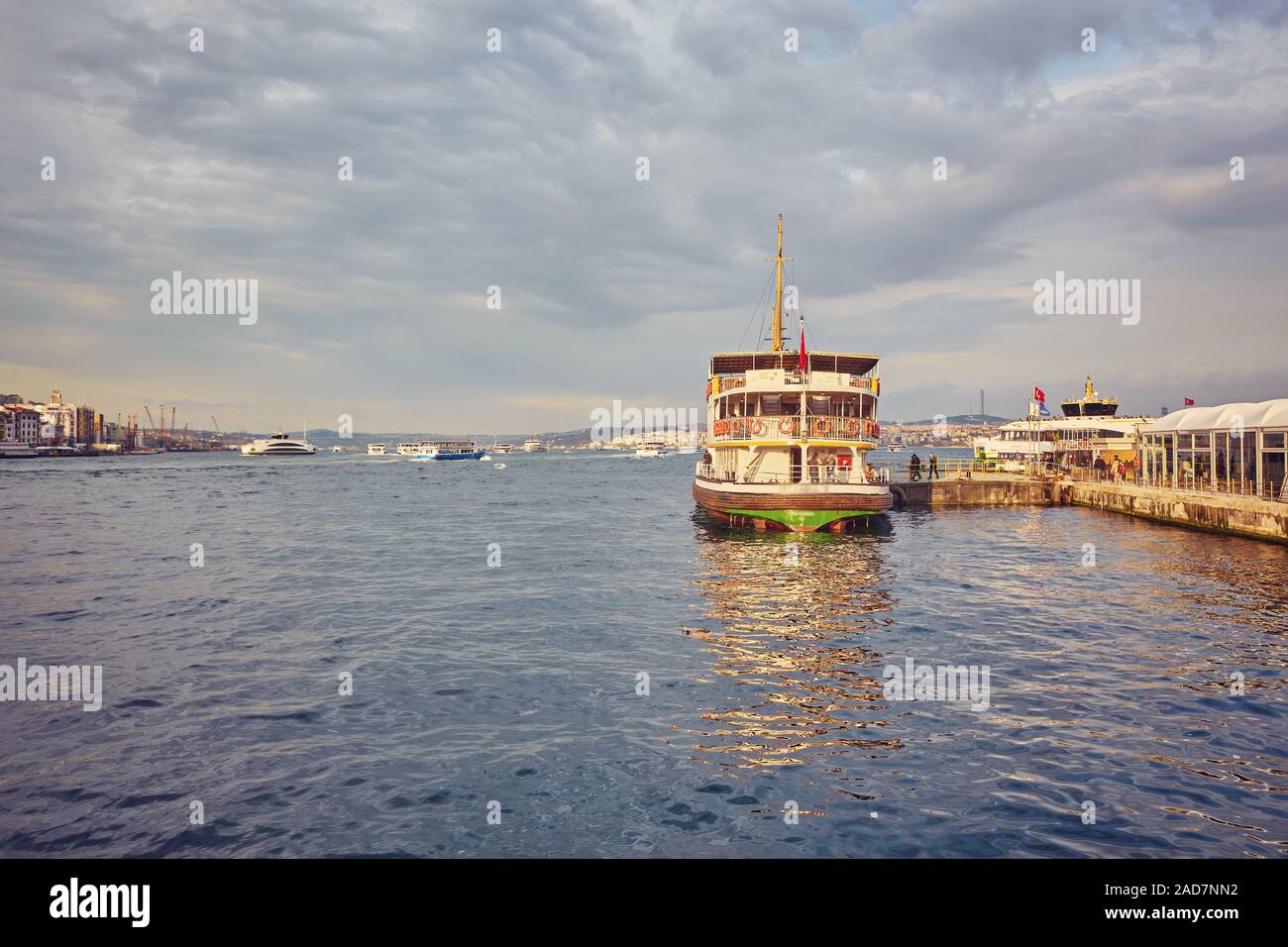 Bosphorus strait with ferry boats on the sunset in Istanbul, Turkey ...