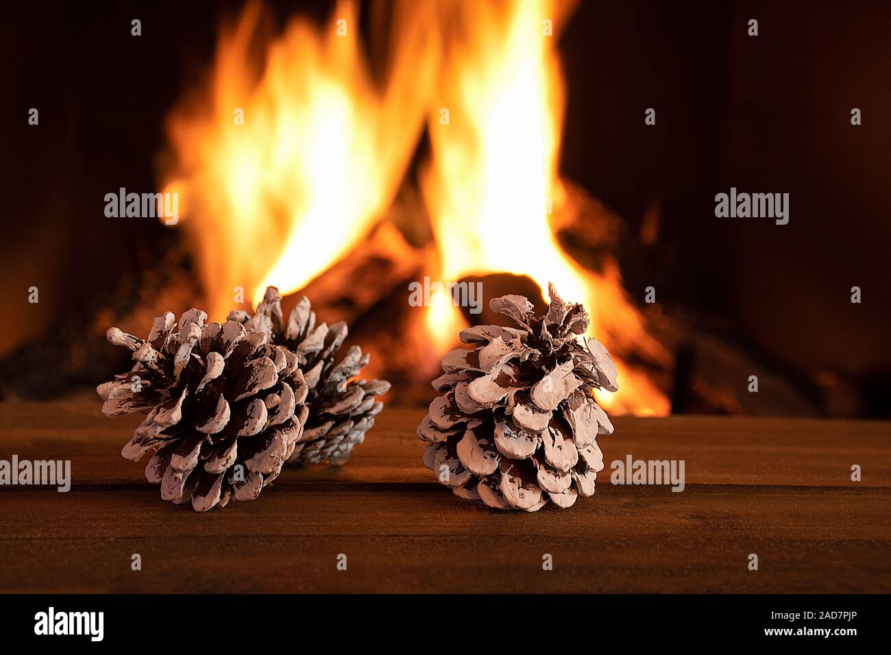 Close Up Of Pine Cones In Front Of Glowing Fireplace Stock Photo