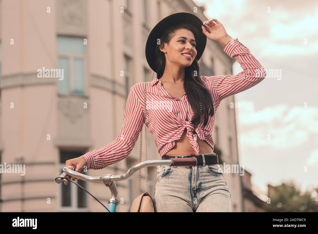 Smiling lady with bike in the street stock photo Stock Photo