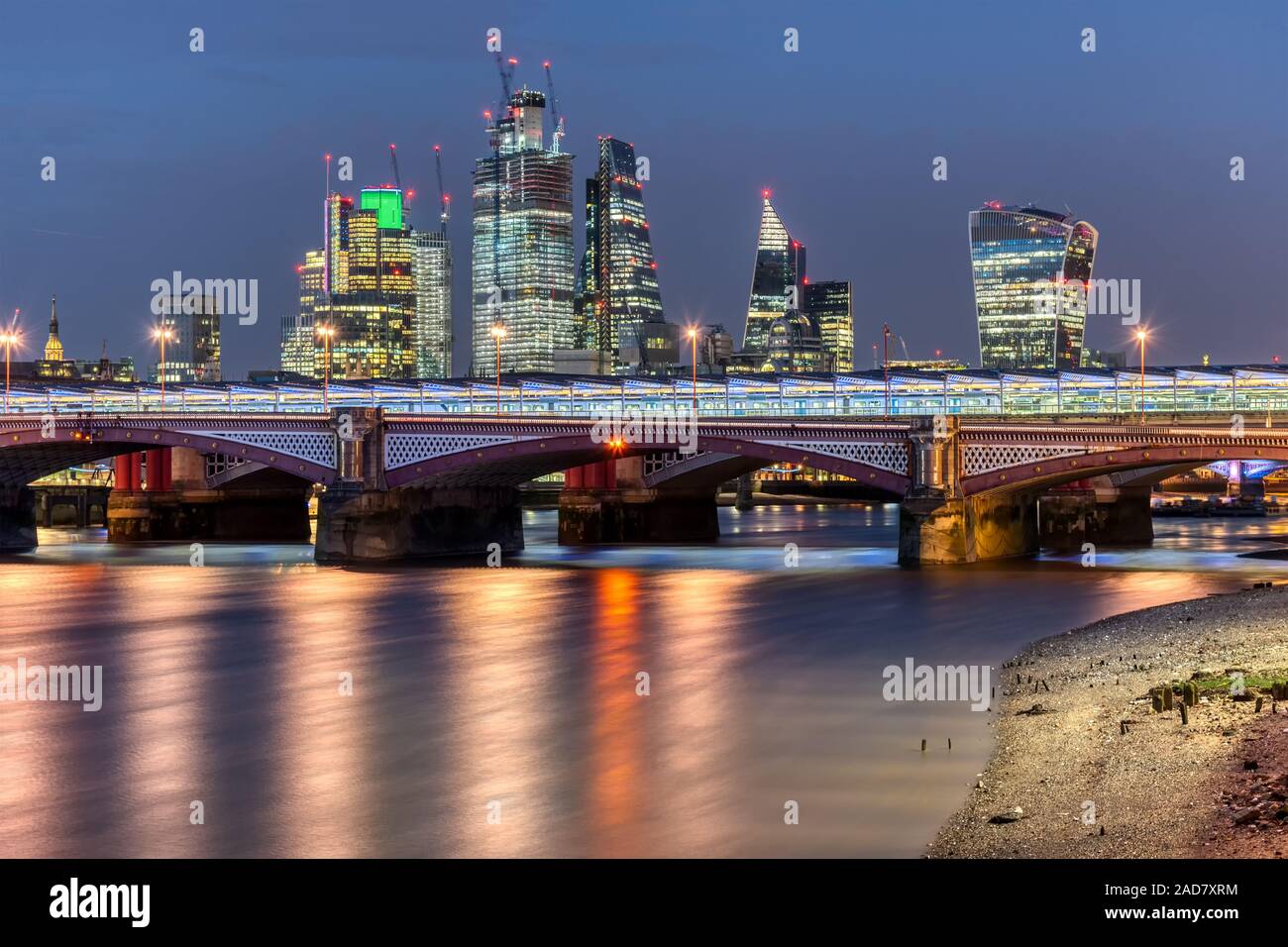Blackfriars Bridge and the skyscrapers of the City of London at night Stock Photo