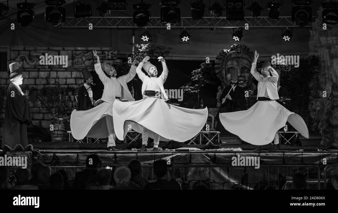 The Turkish whirling dancers or Sufi whirling dancers performing of the Mevlevi (whirling dervish) sema  at the festival LO SPIRITO DEL PIANETA Stock Photo