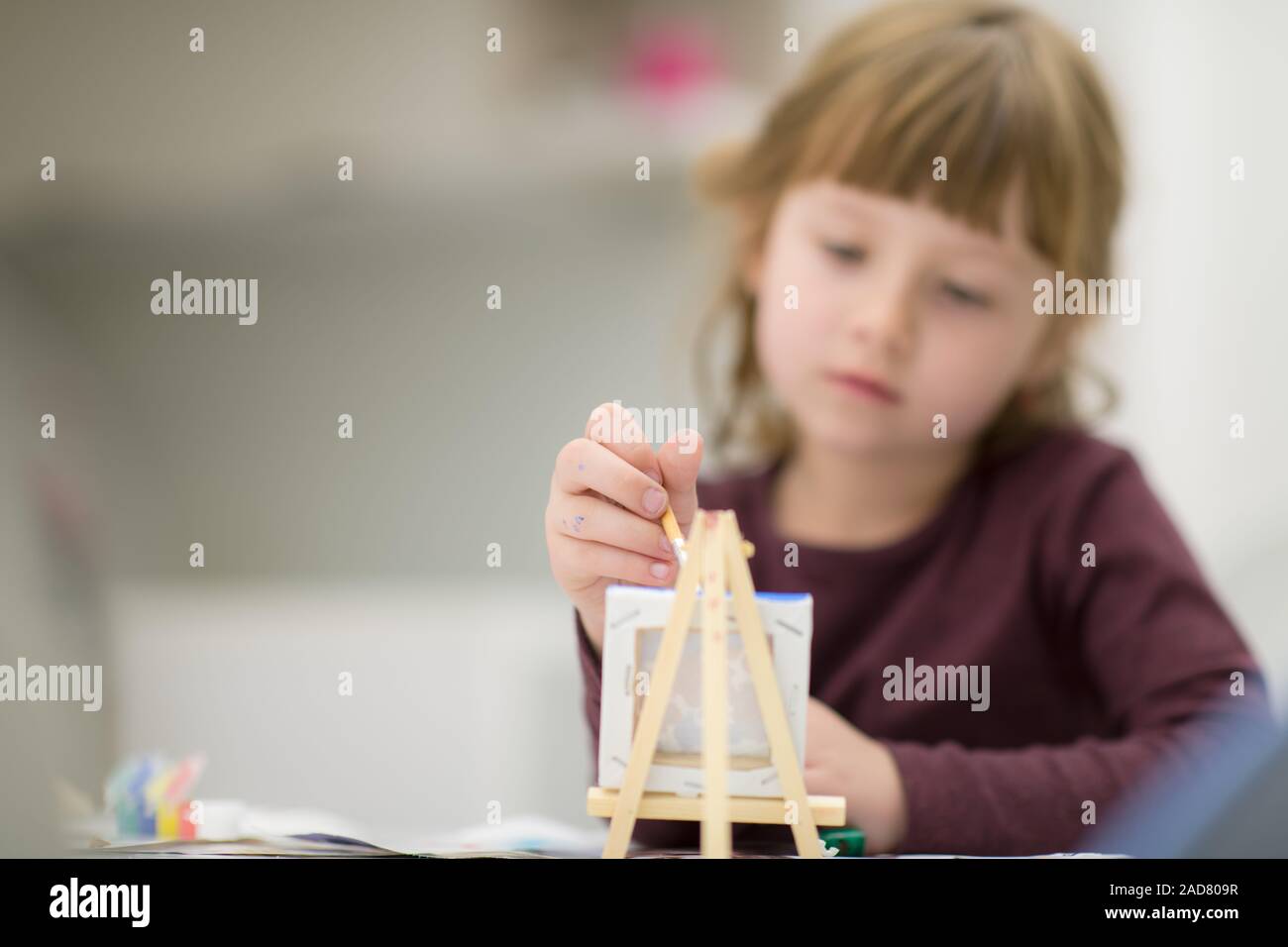 little girl painting on canvas Stock Photo - Alamy