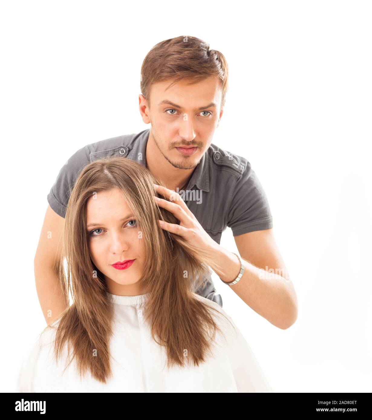 Professional hairdresser with long hair model, isolated on white Stock