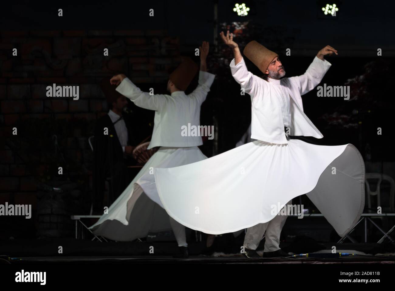 The Turkish whirling dancers or Sufi whirling dancers performing of the Mevlevi (whirling dervish) sema at the festival LO SPIRITO DEL PIANETA Stock Photo