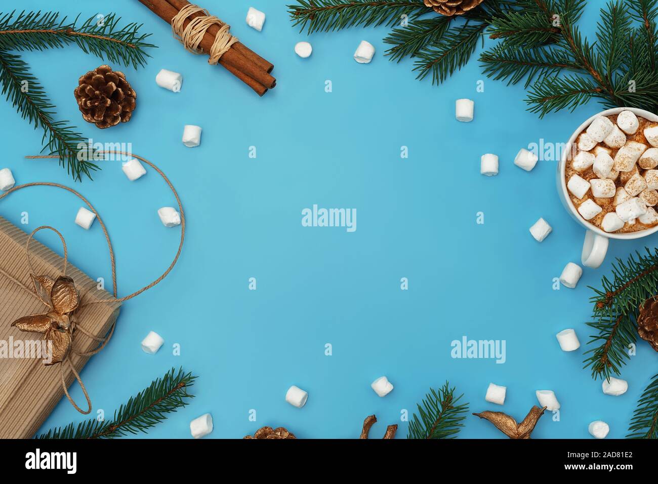 Trendy Christmas Background Of Hot Chocolate With Marshmallow Ginger Cookies Craft Gift Box Christmas Tree Branches With Golden Cones On Cyan Blue Stock Photo Alamy