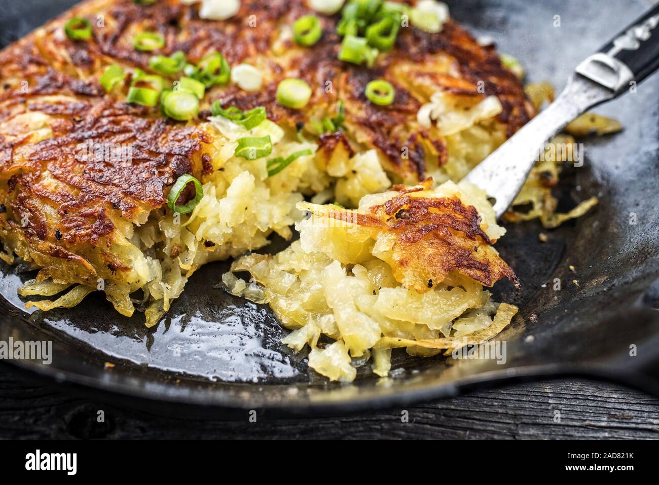 Traditional Swiss hash browns as side dish with leek as closeup in a