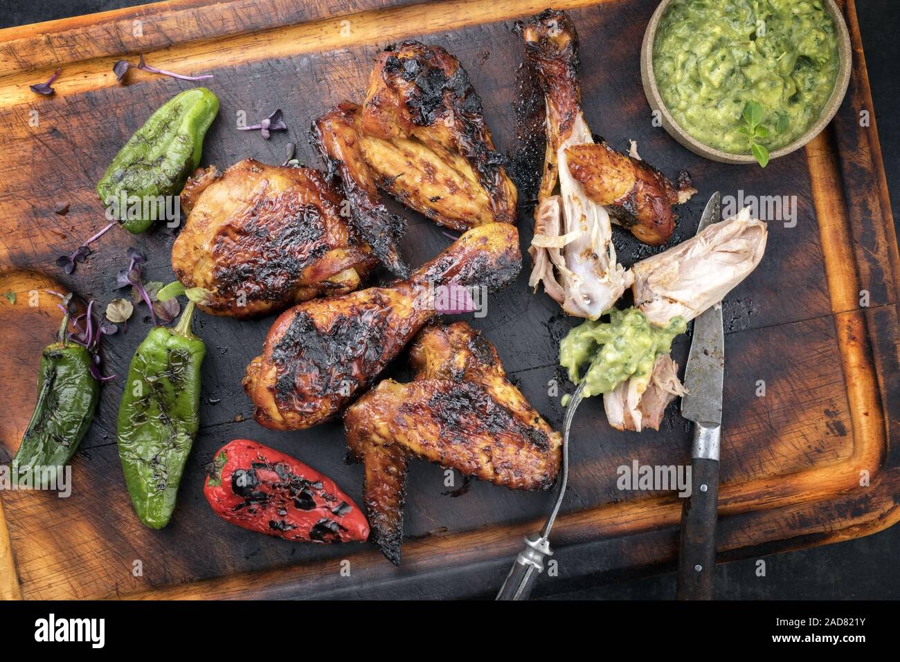 Traditional Caribbean barbecue chicken wings and drumsticks with