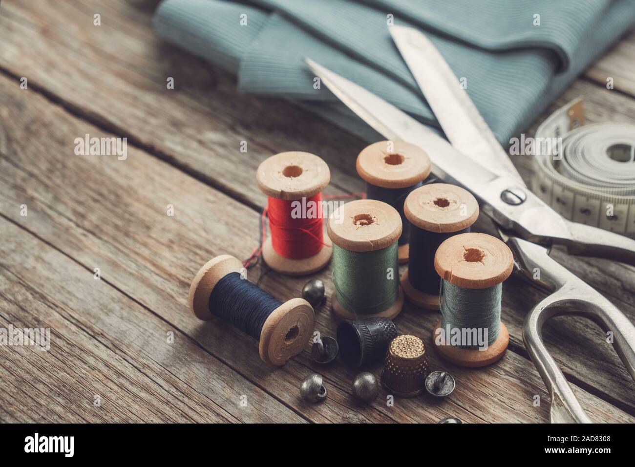 Retro sewing items tailoring scissors, thimbles, buttons, wooden