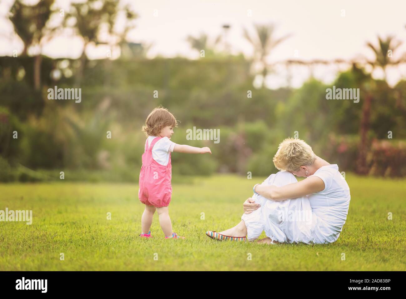 mother and little daughter playing at backyard Stock Photo