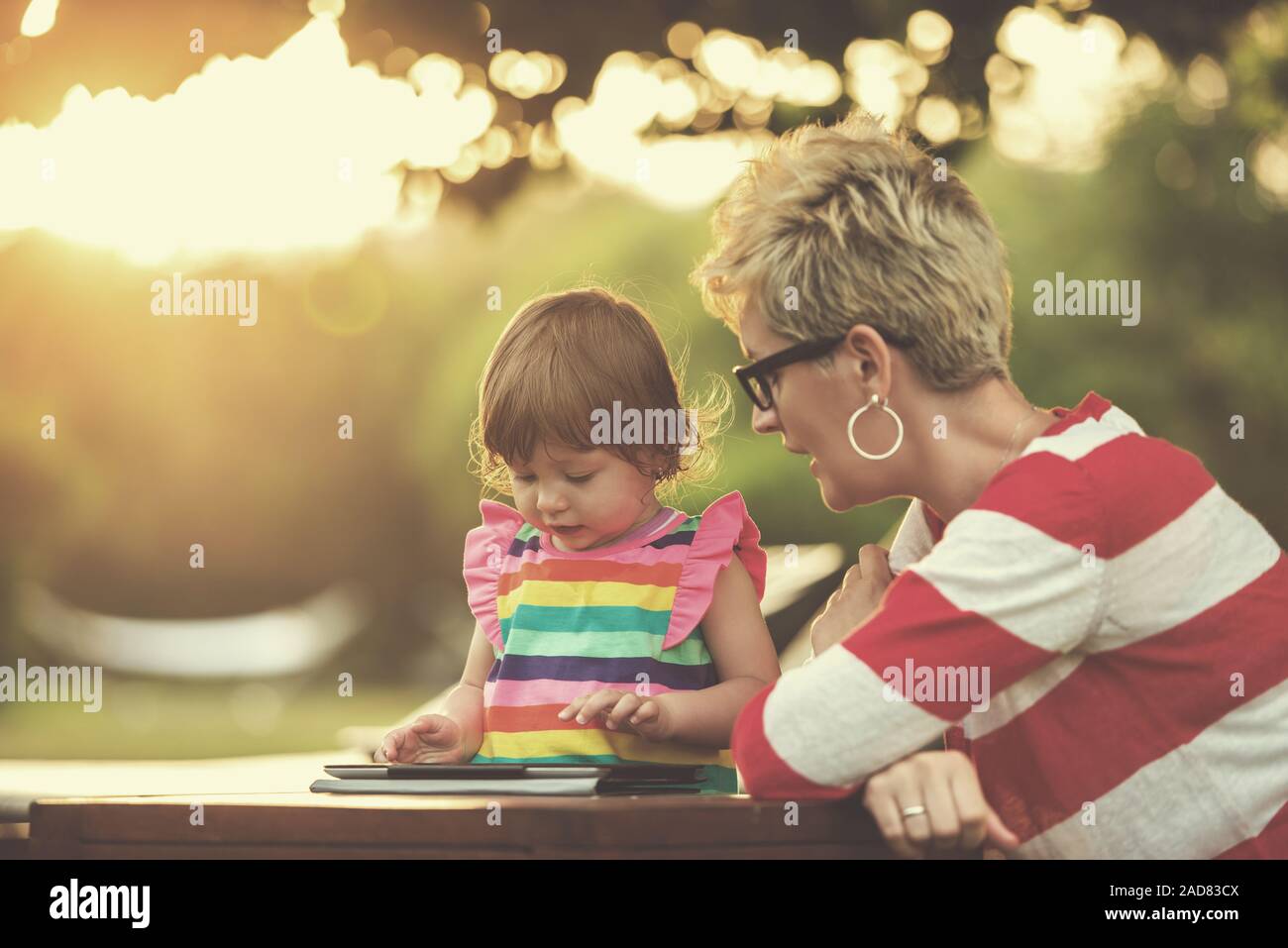 mom and her little daughter using tablet computer Stock Photo