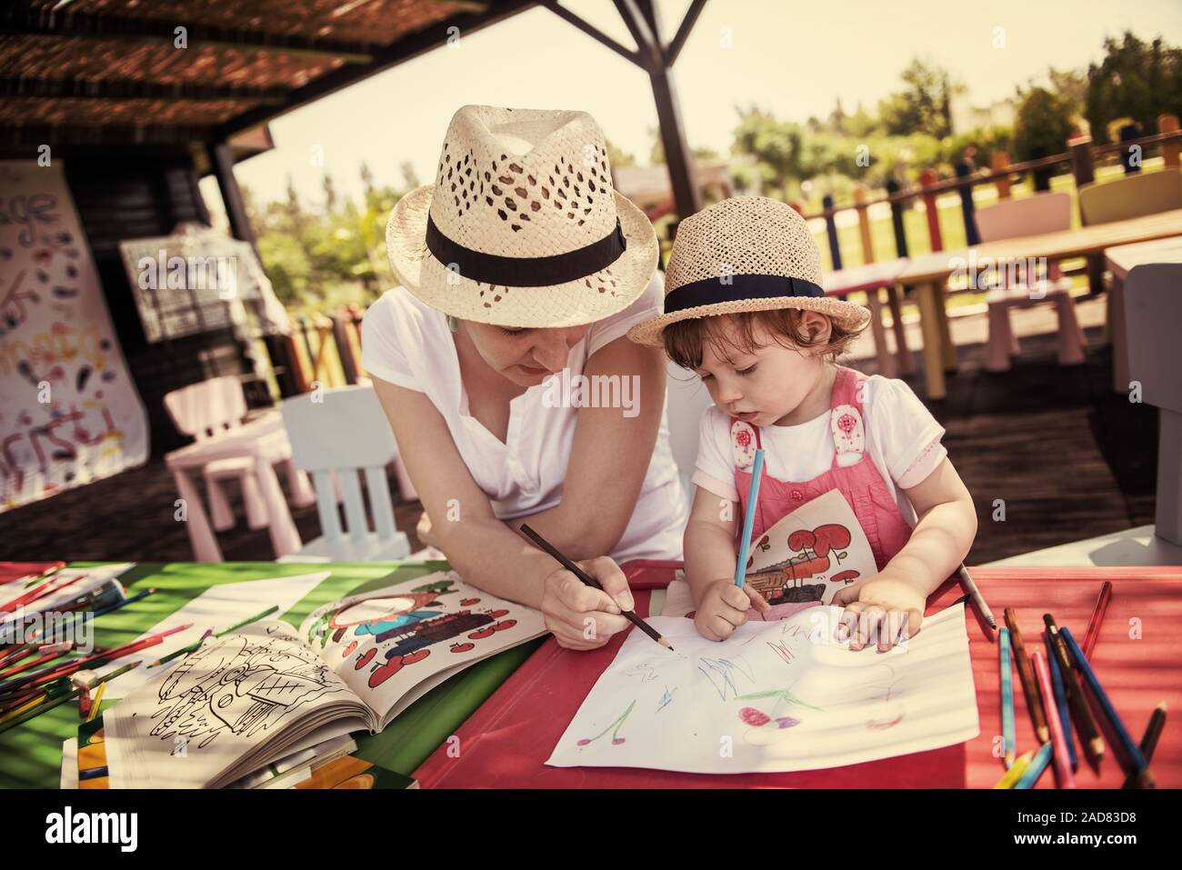 mom and little daughter drawing a colorful pictures Stock Photo