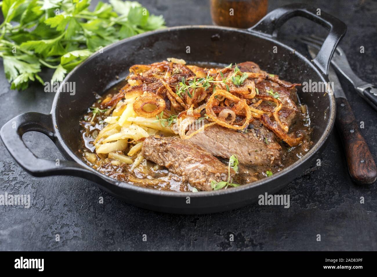 Traditional dry aged sliced roast beef with fried onion rings and Swiss ...