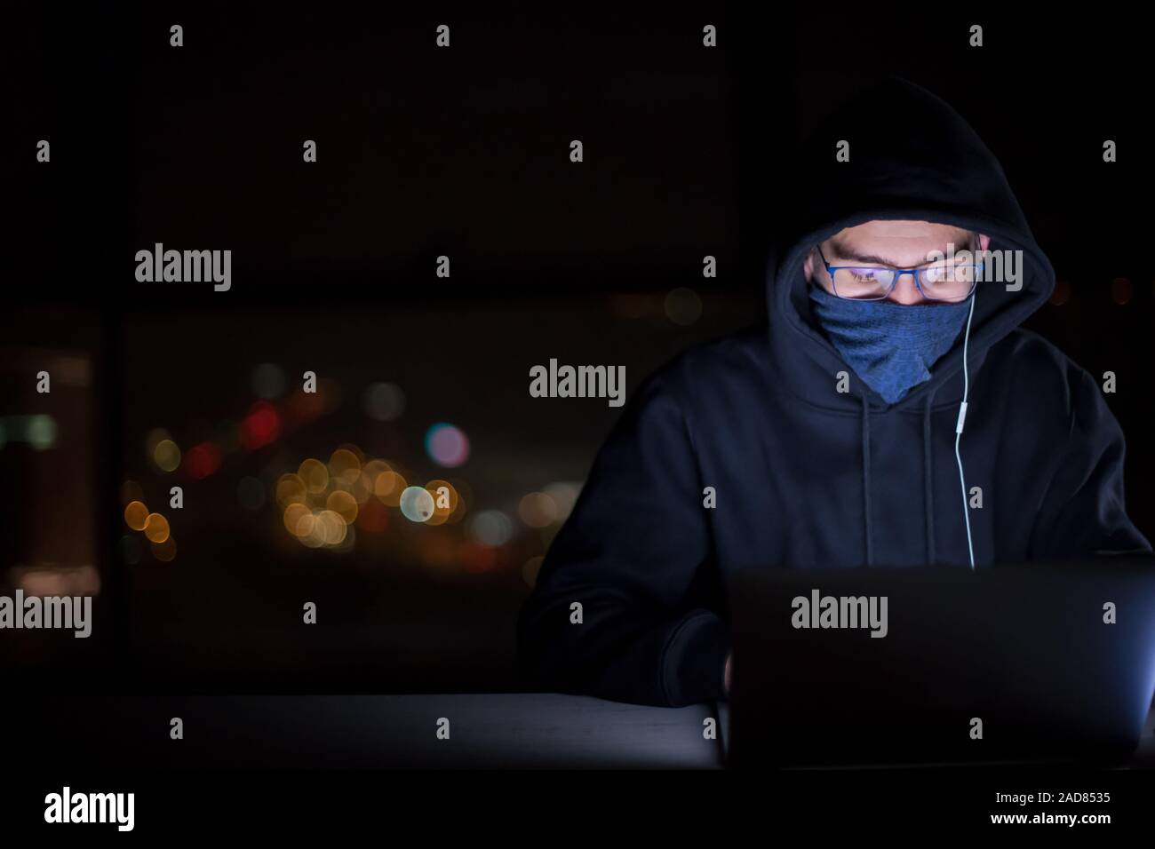 hacker using laptop computer while working in dark office Stock Photo ...