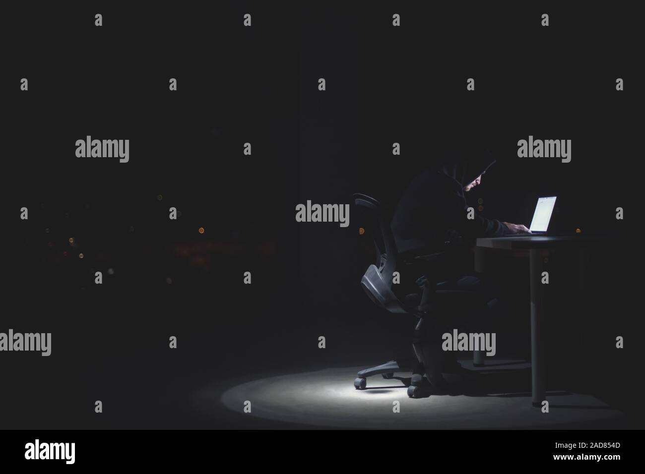 hacker using laptop computer while working in dark office Stock Photo ...