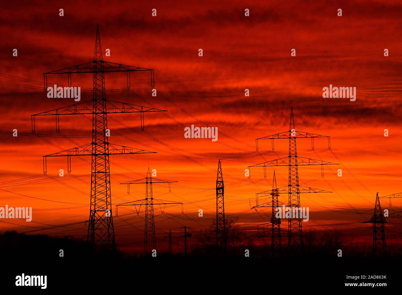 Sunset over the power line and high-voltage line on the Dinkelberg in southern Germany Stock Photo