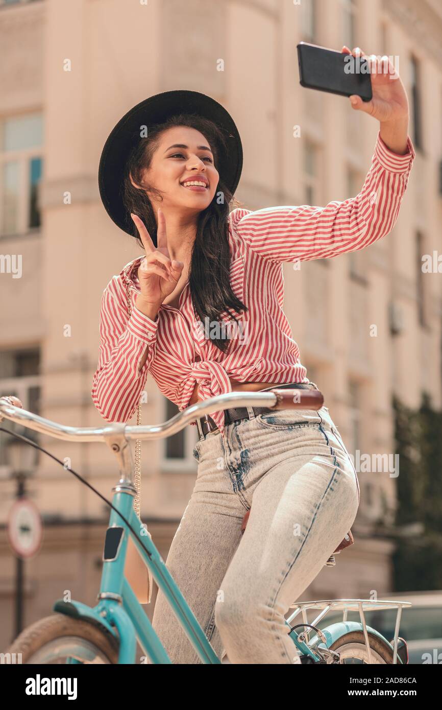 Pretty woman posing for selfie on the bike stock photo Stock Photo