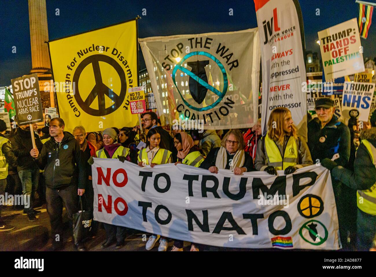 London, UK. 3rd December 2019. The march assmebles behind the 'No To Trump  No To NATO' banner. After the rally in Trafalgar Square over a thousand  people marched down the Mall to