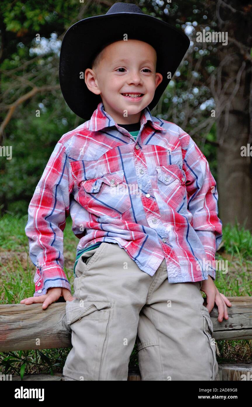 boy portrait wearing cowboy hat and boots Stock Photo