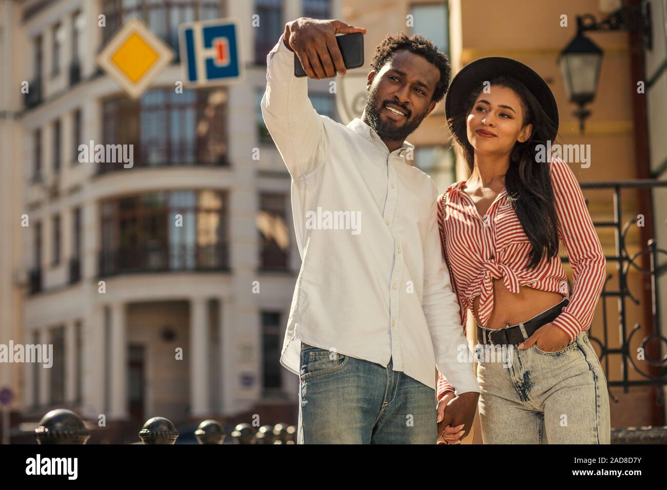 Young man looking confident while taking selfie with girlfriend Stock Photo