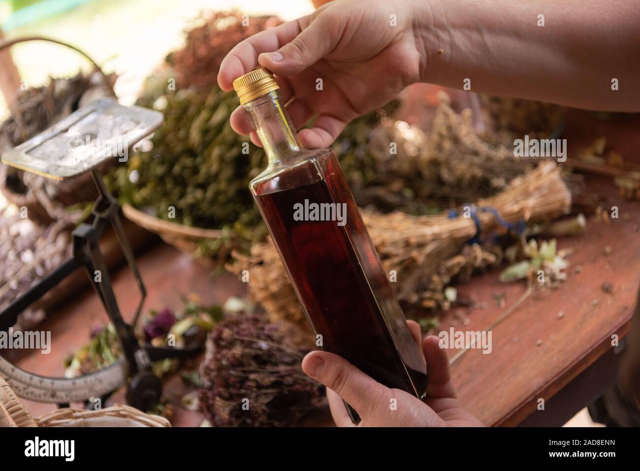 potion bottle in hand of herbalist Stock Photo