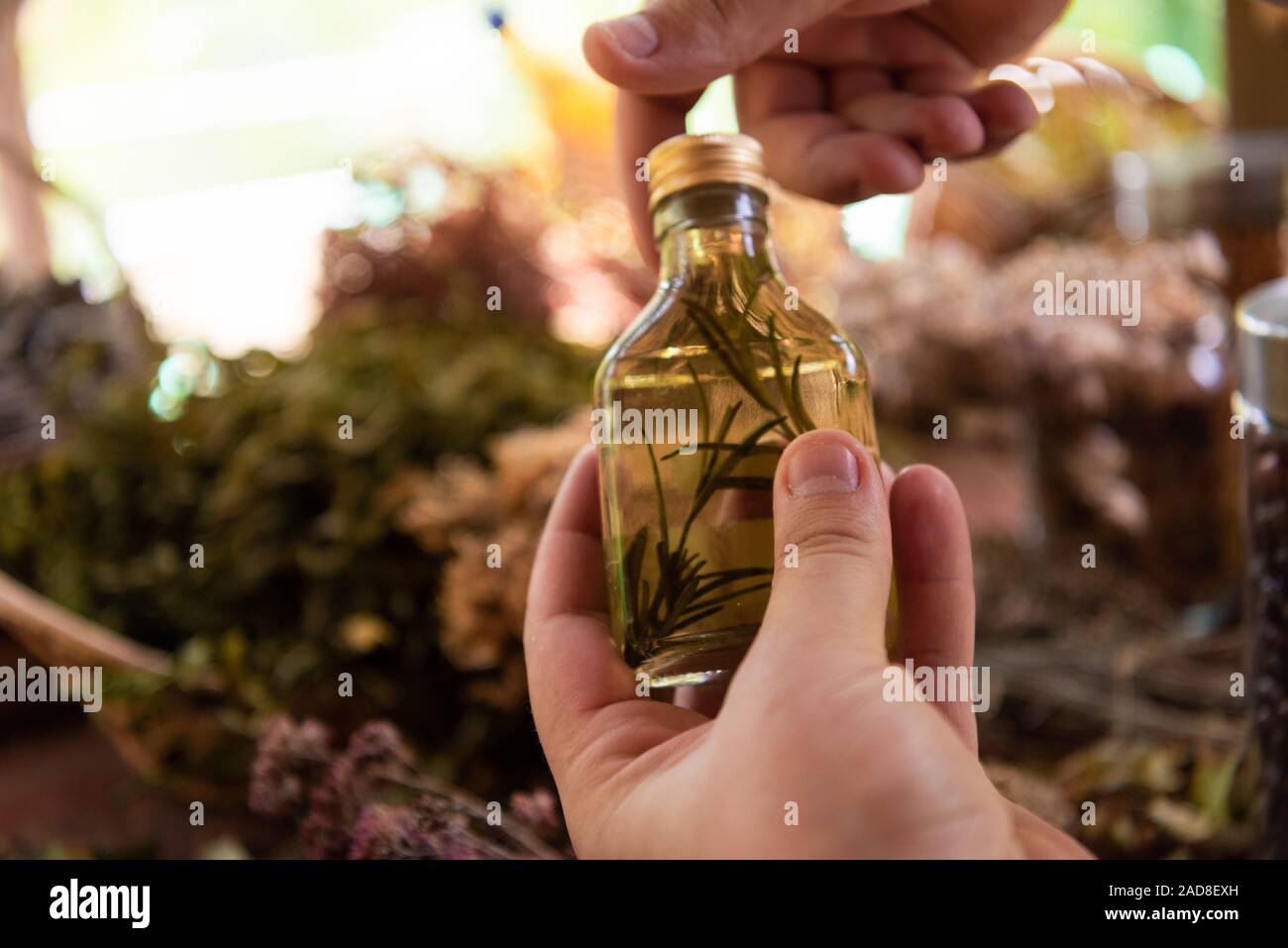 potion bottle in hand of herbalist Stock Photo