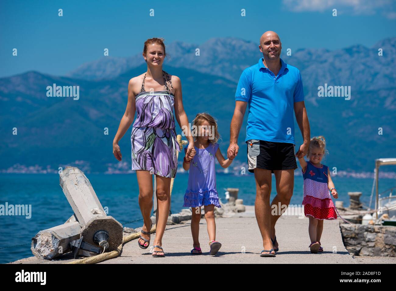 young happy family walking by the sea Stock Photo