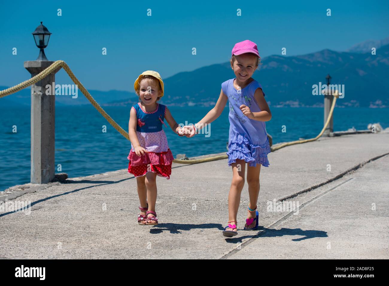 little sisters running on the beach coast Stock Photo
