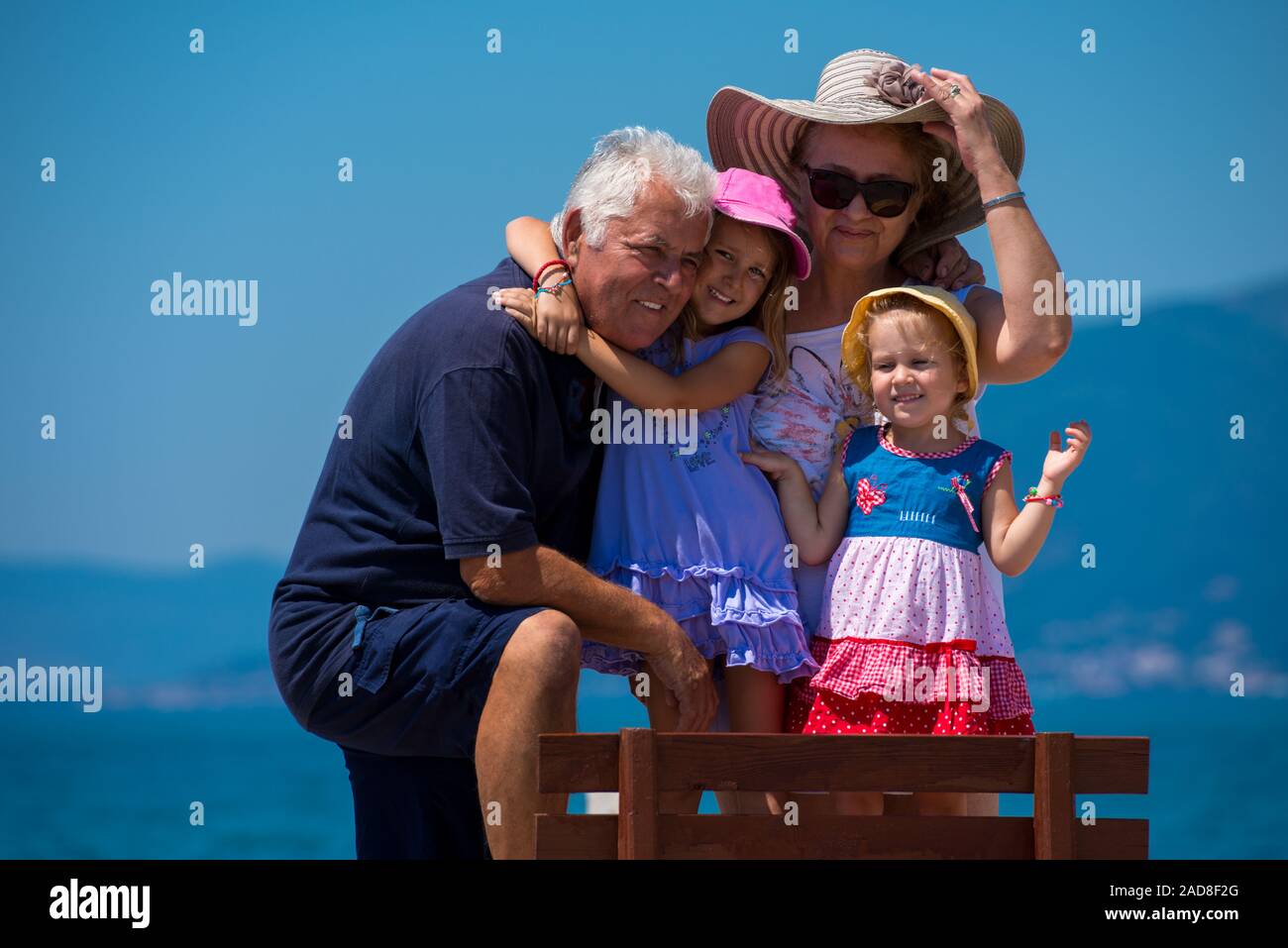 portrait of grandparents and granddaughters by the sea Stock Photo