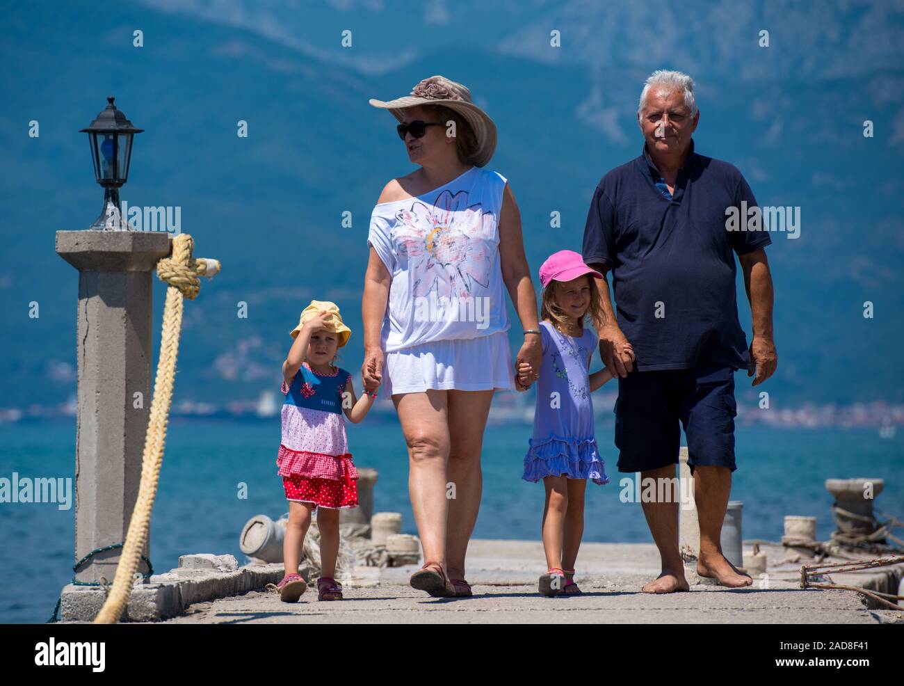 grandparents and granddaughters walking by the sea Stock Photo