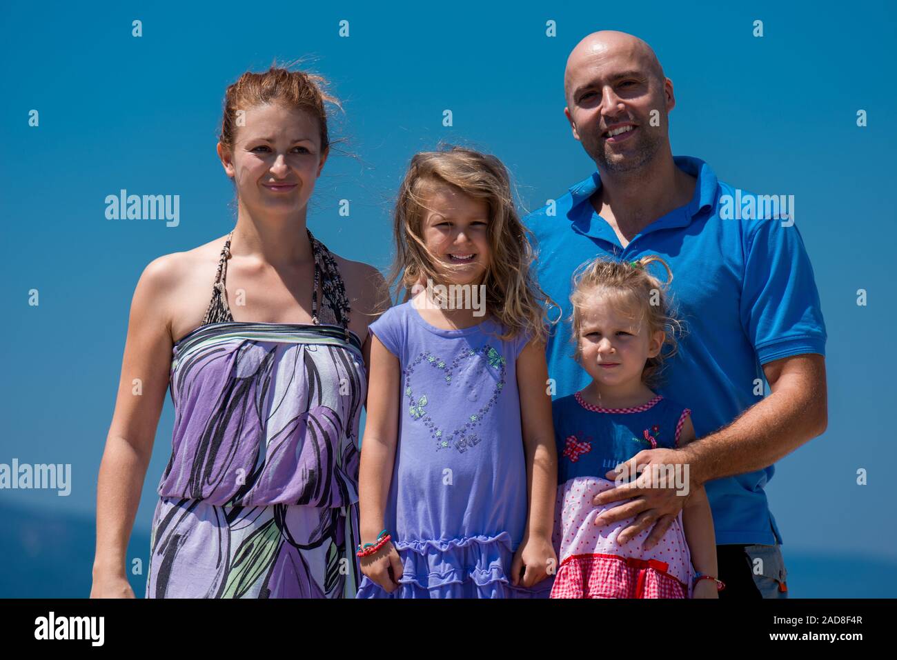 portrait of young happy family with daughters by the sea Stock Photo