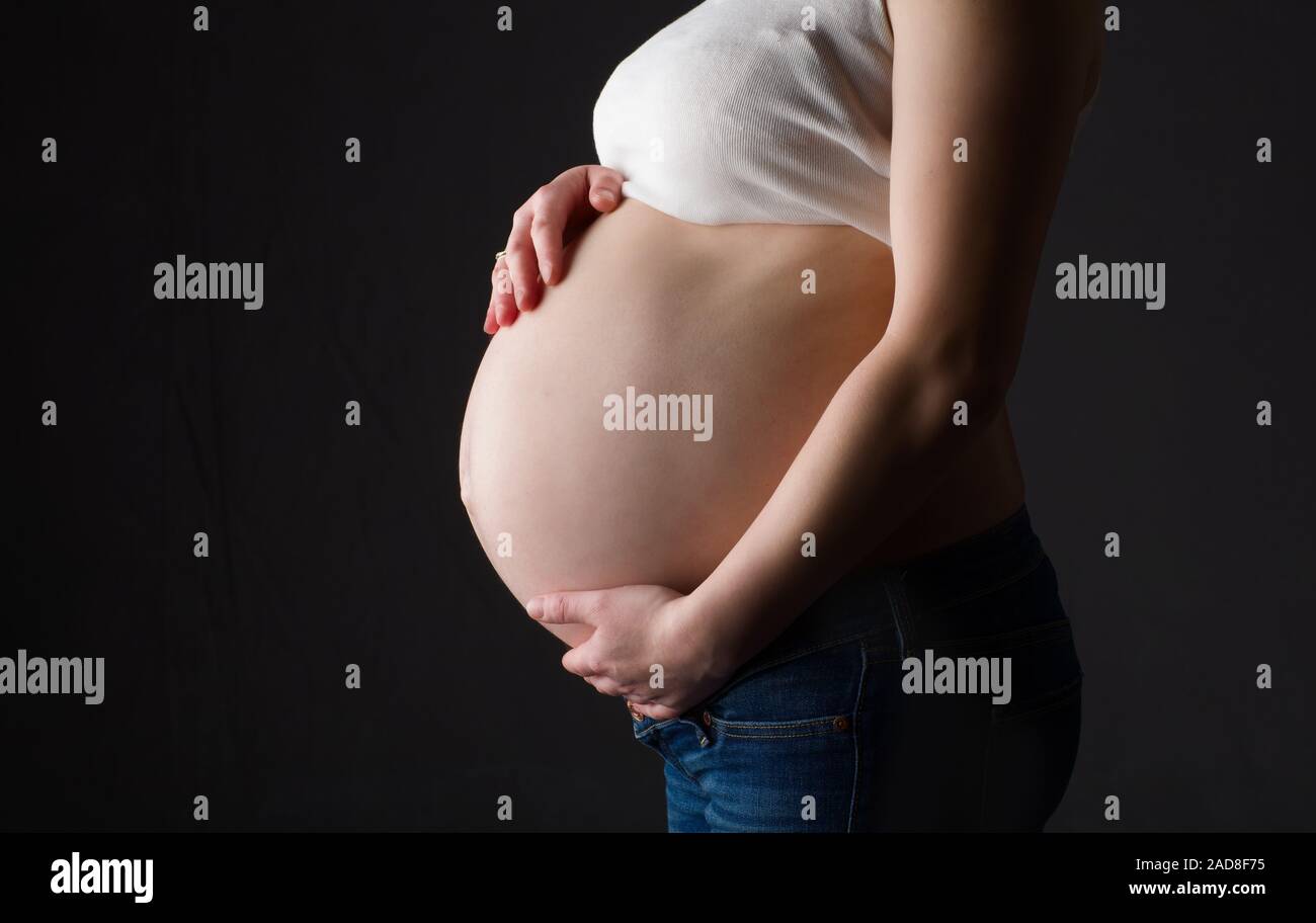 pregnant woman, expectant mother on black background, Stock Photo