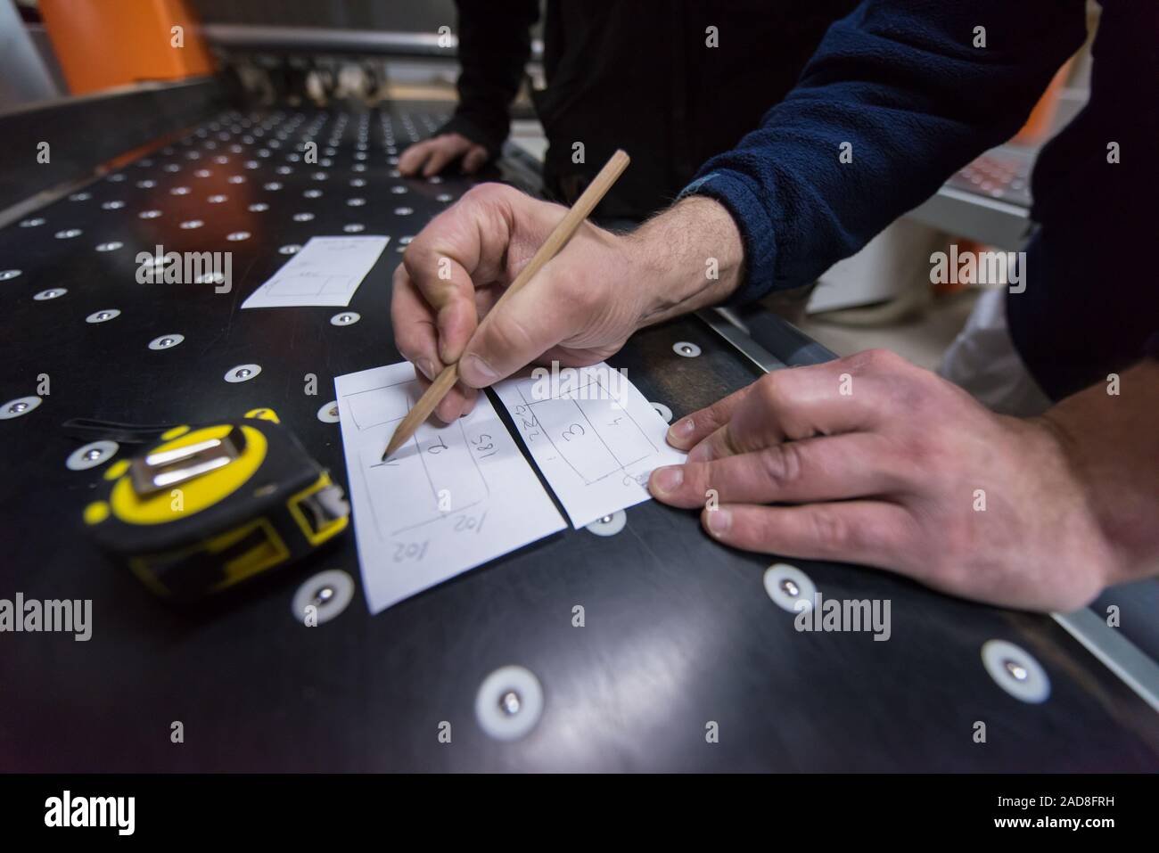 carpenters calculating and programming a cnc wood working machine Stock Photo