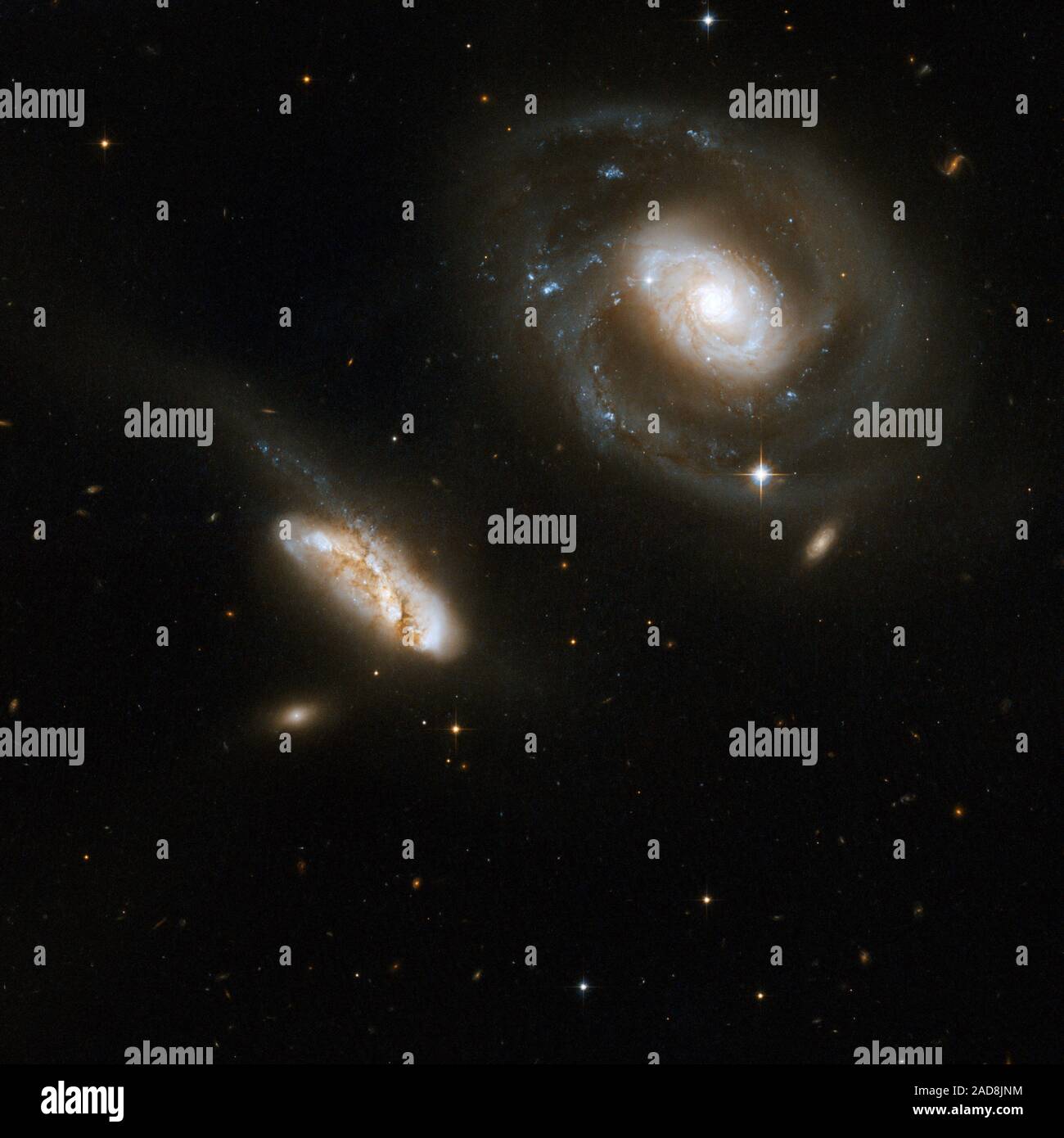 This is a stunning pair of interacting galaxies, the barred spiral Seyfert 1 galaxy NGC 7469 (Arp 298, Mrk 1514), a luminous infrared source with a powerful starburst deeply embedded into its circumnuclear region, and its smaller companion IC 5283. This system is located about 200 million light-years away from Earth in the constellation of Pegasus, the Winged Horse.   This image is part of a large collection of 59 images of merging galaxies taken by the Hubble Space Telescope and released on the occasion of its 18th anniversary on 24th April 2008.    Object Names: NGC 7469, QSO J2303+0852, Arp Stock Photo