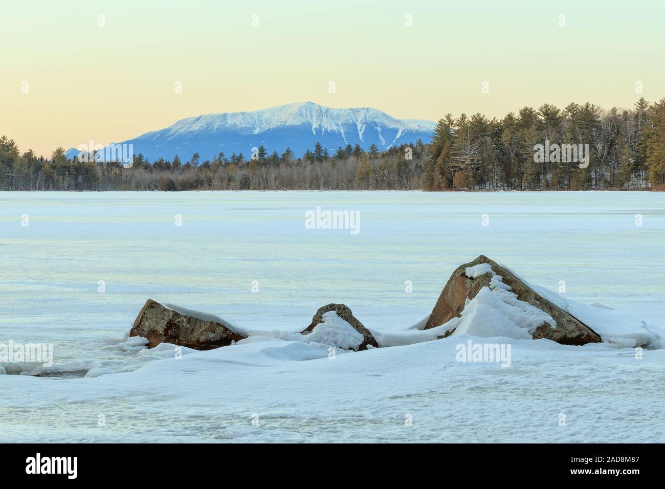 Katahdin behind a frozen pond with jagged rocks in the foreground. Stock Photo