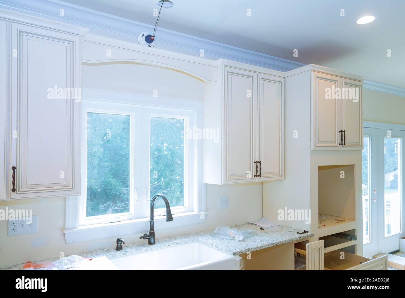 Modern domestic kitchen cabinets with new appliances and sink in ...