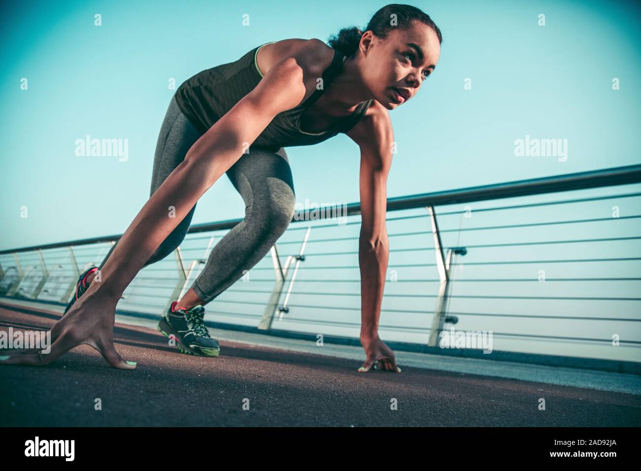 Professional sportswoman with hands on the ground stock photo Stock Photo