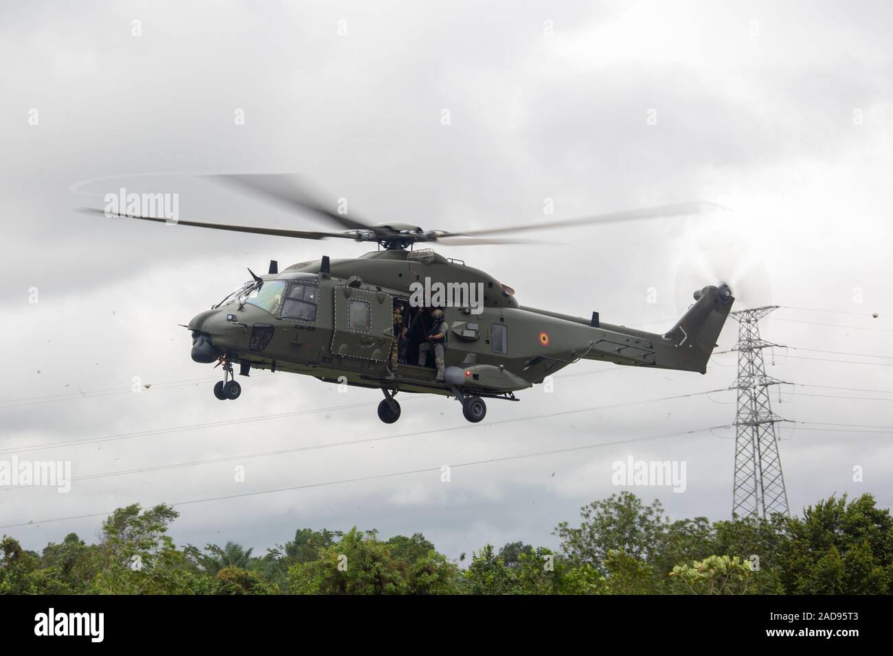 A Belgian Army NH90 Eurocopter with the 1st Wing Mobile Air Operation Team, moves into position during a fast-rope training exercise at Libreville, Gabon, Nov. 20, 2019. SPMAGTF-CR-AF is deployed to conduct crisis-response and theater-security operations in Africa and promote regional stability by conducting military-to-military training exercises throughout Europe and Africa. (U.S. Marine Corps photo by Cpl. Kenny Gomez) Stock Photo