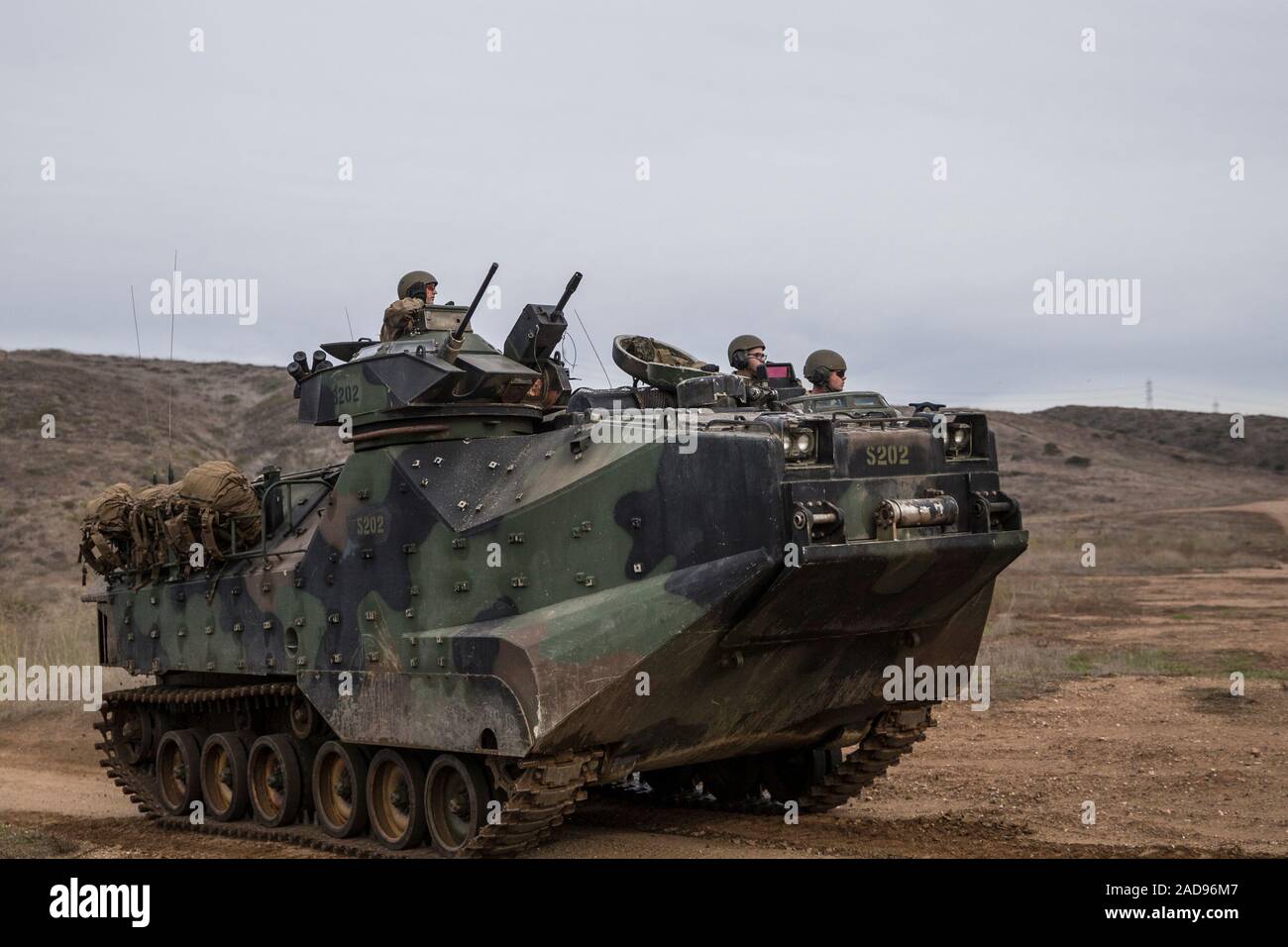 U.S. Marines with Assault Amphibian School, Training and Education Command, engage in basic land and tactics operations in an AAV-P7/A1 Amphibious Assault Vehicle at the Oscar Two training area on Marine Corps Base Camp Pendleton, California, Dec. 2, 2019. This training teaches students how to operate AAVs on land and employ them in a tactical formation. (U.S. Marine Corps photo by Lance Cpl. Angela Wilcox) Stock Photo