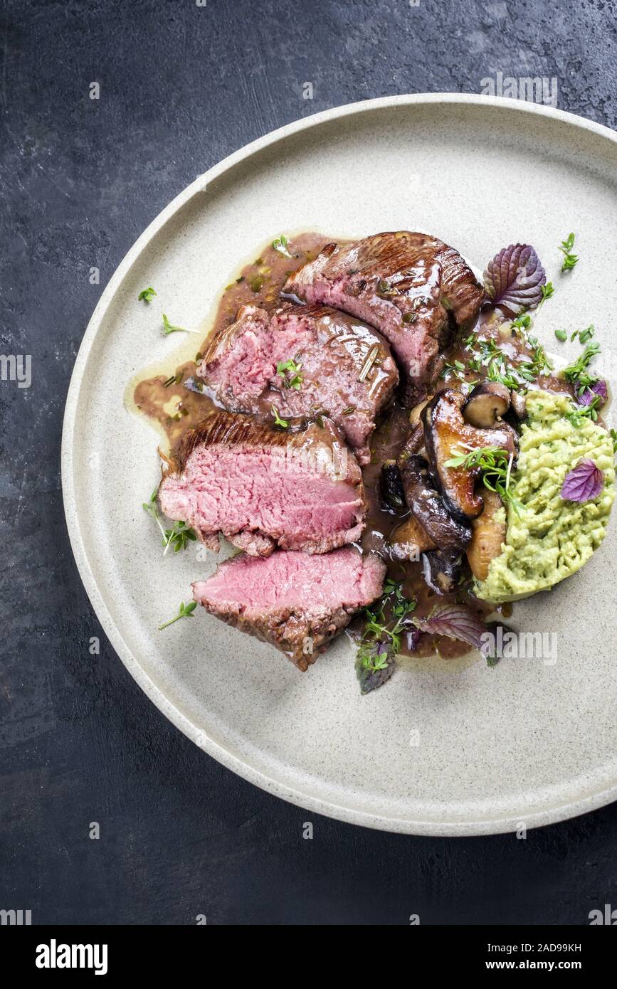 Barbecue aged sliced venison sirloin with mushroom in gammon red wine