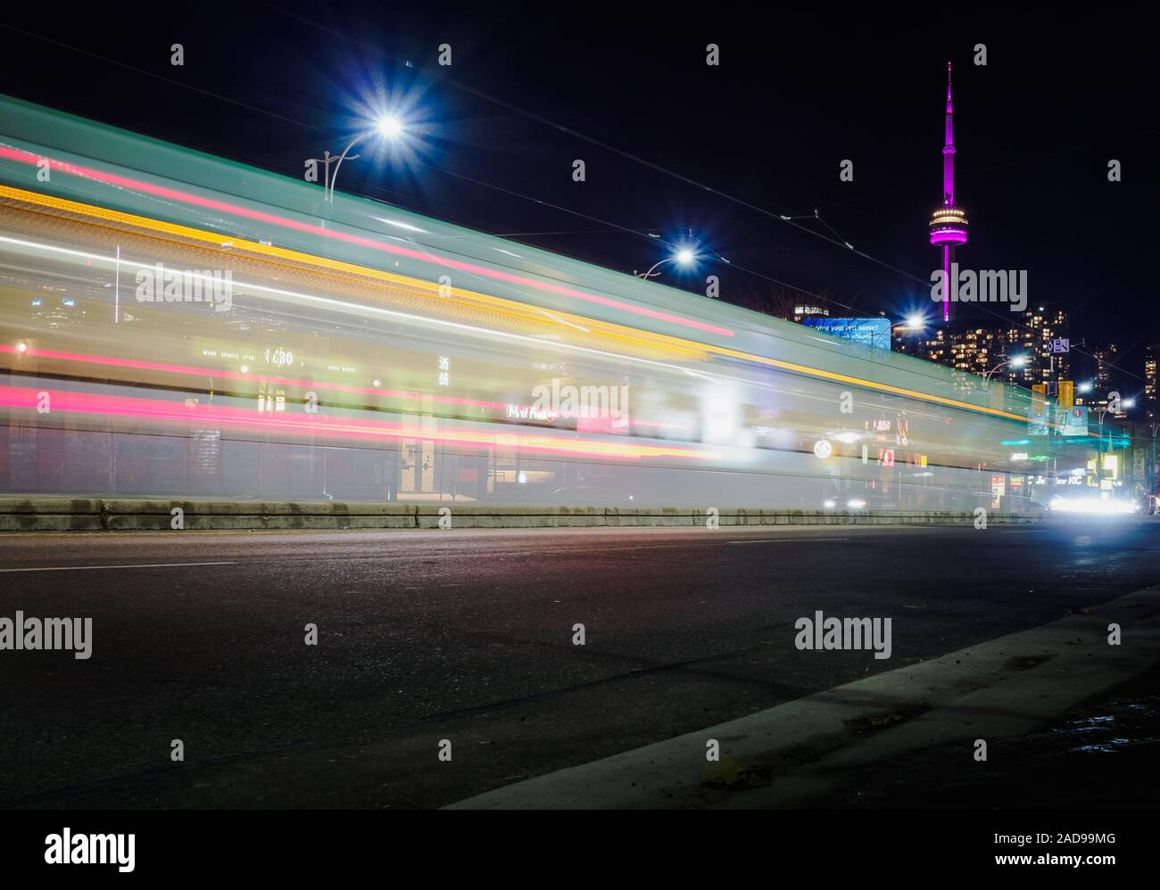CN Tower with long exposure light trail by night - Toronto, Ontario, Canada showing modern futuristic city Stock Photo