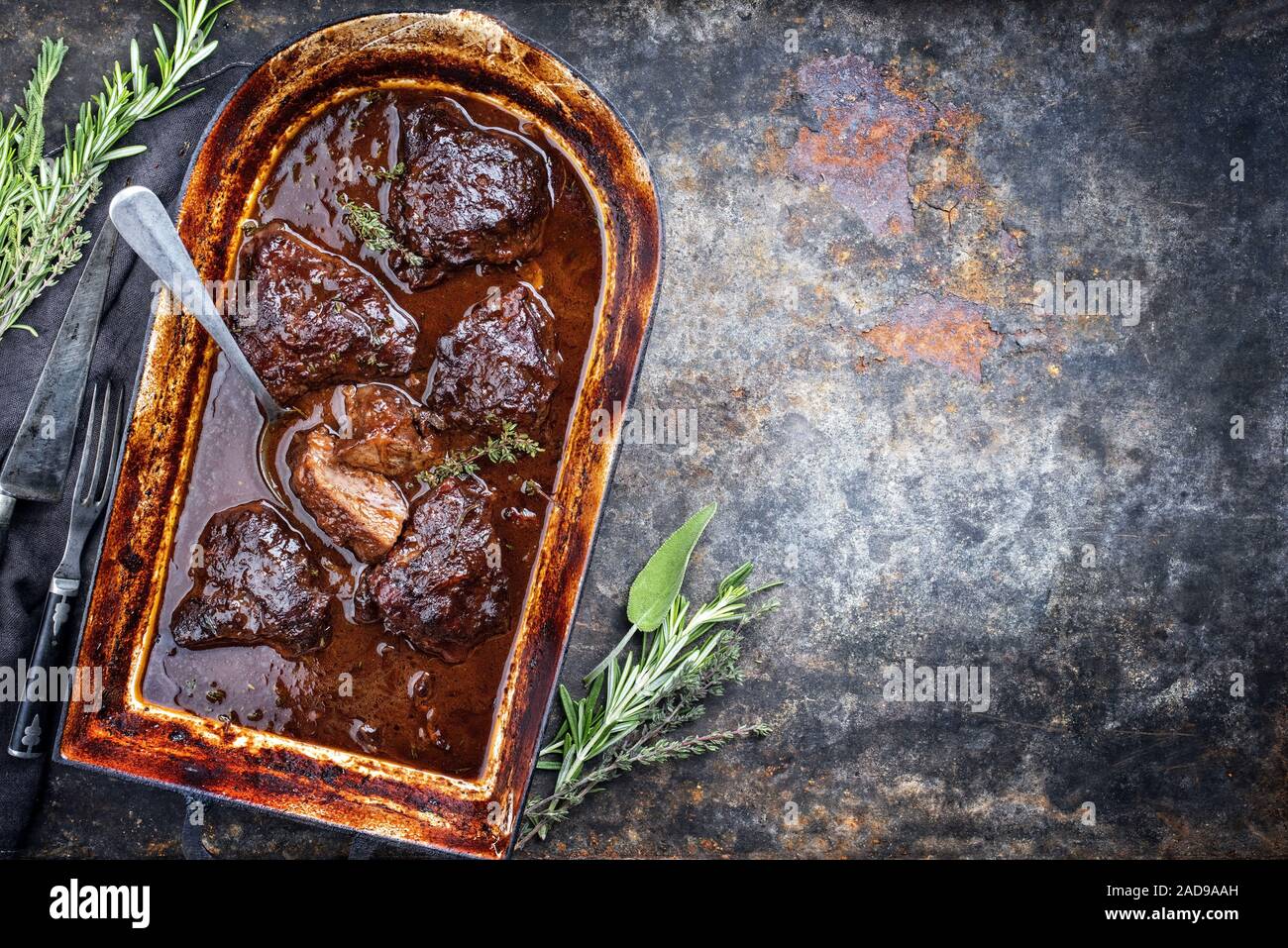 Traditional German braised veal cheeks in brown red wine sauce with