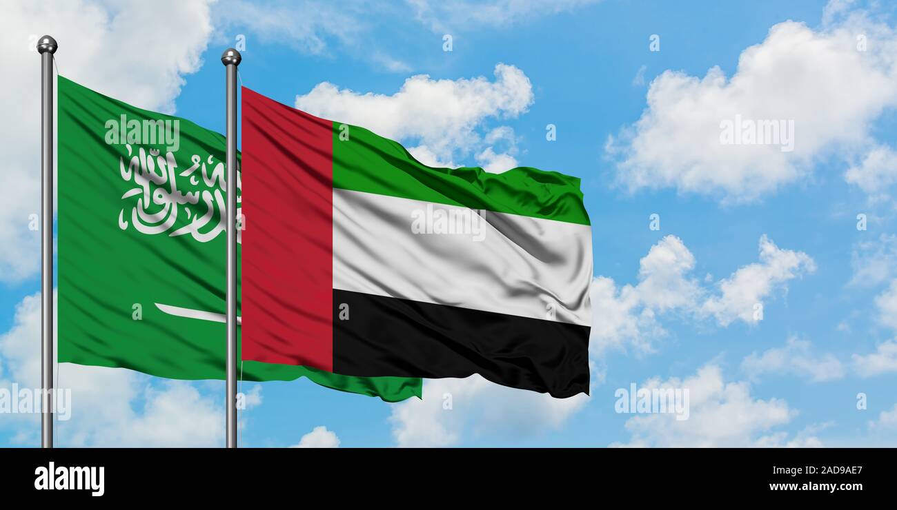 Saudi Arabia and United Arab Emirates flag waving in the wind against ...