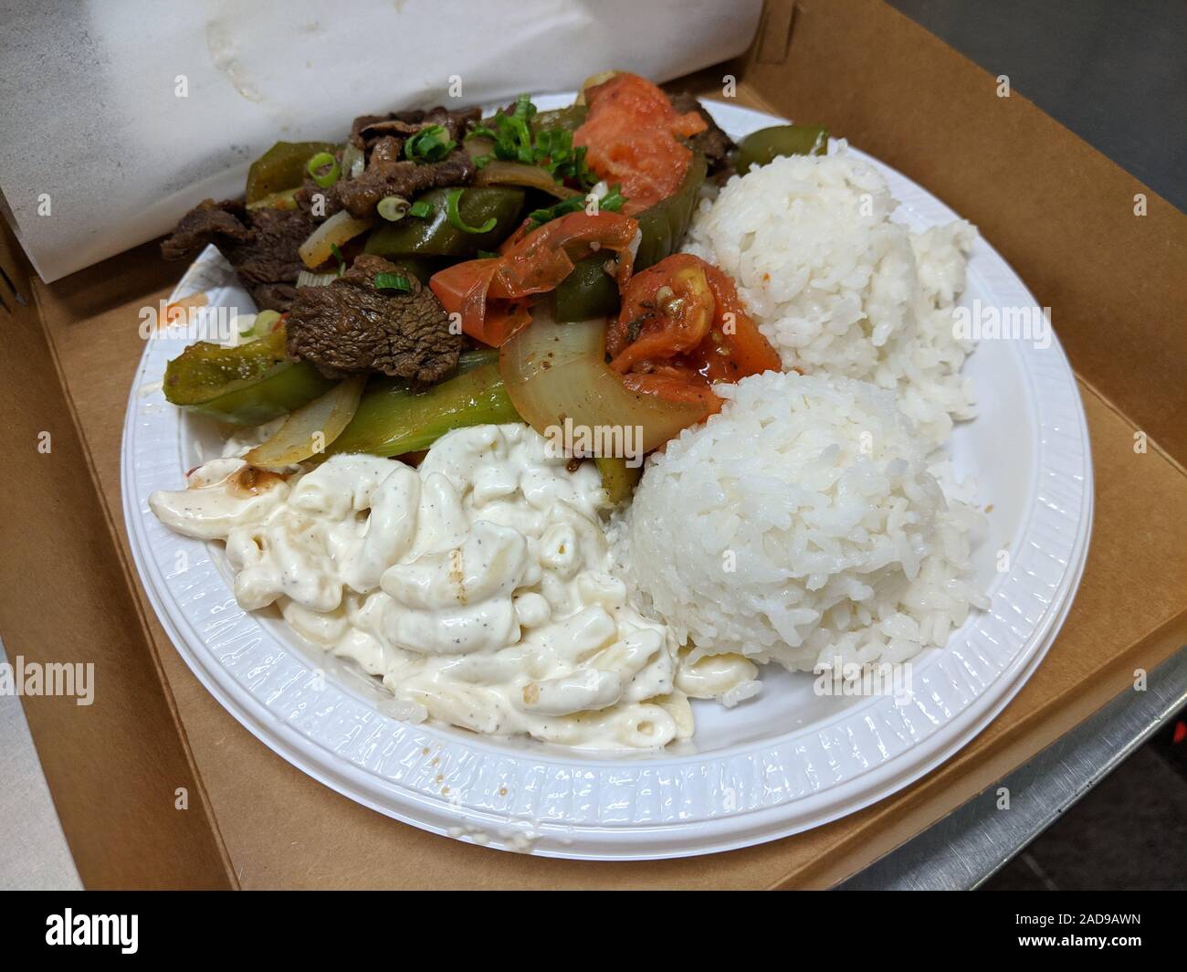 Chopped Steak with Vegetables Plate - Tender sliced beef stir-fried with onions, celery, bell peppers and tomatoes with white rice and mac salad. Stock Photo