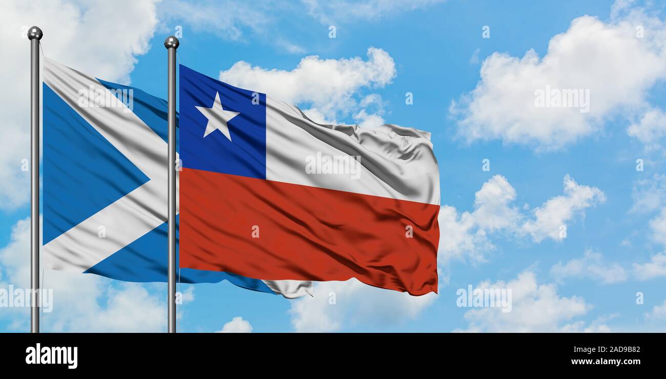 Scotland and Chile flag waving in the wind against white cloudy blue sky together. Diplomacy concept, international relations. Stock Photo